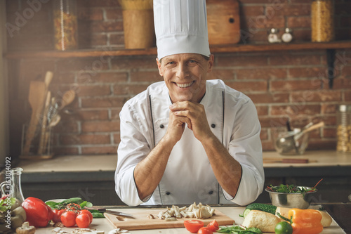 Obraz na plátne Mature man professional chef cooking meal indoors