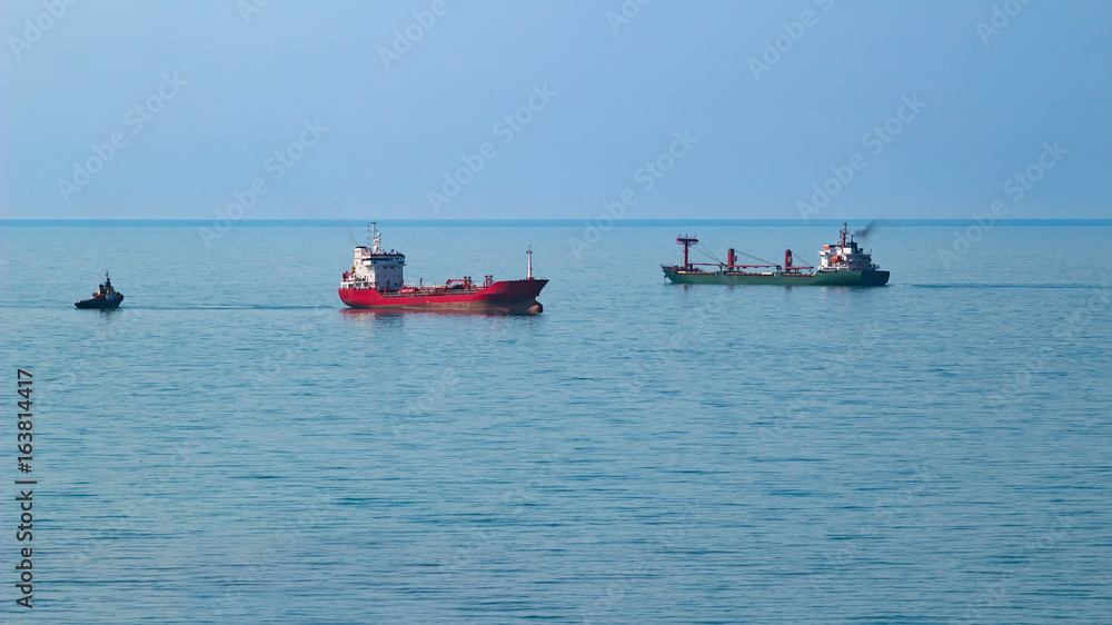 Two tankers at sea and blue sky background Two tankers at sea and blue sky background