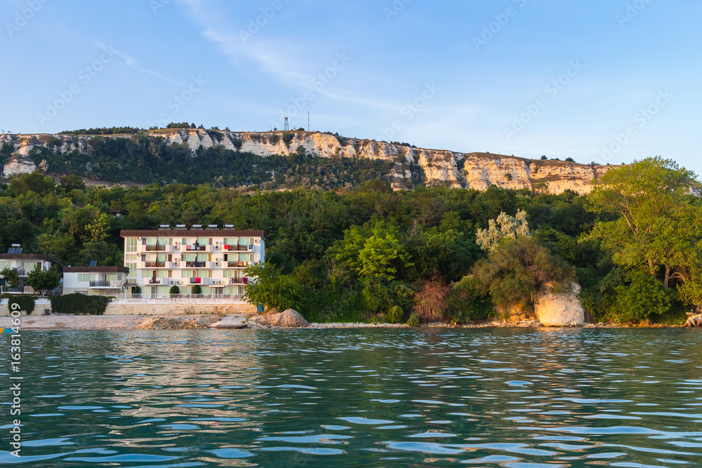 View of the buildings and big rock hills in Balchik city on black sea coast in Bulgaria at gold sunset time