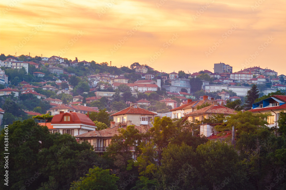 Golden sunset scenery view on houses on the hill in Balchik city, Bulgaria