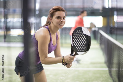 Paddle tennis sportswomen looking at camera in match