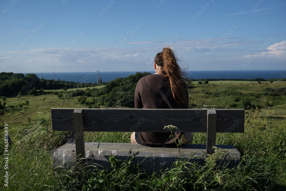 a girl admires a view of the sea in the island Rugen