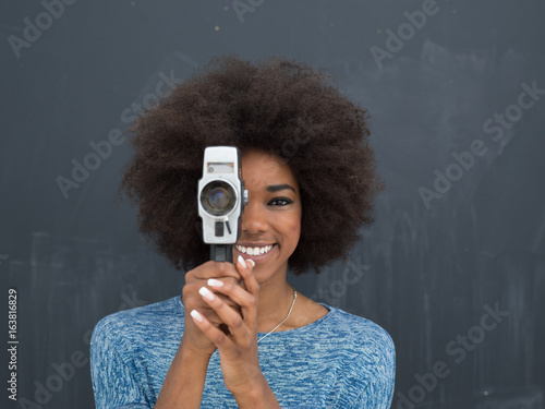 Εκτύπωση καμβά african american woman using a retro video camera