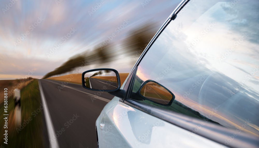 A view of a car passing by the road