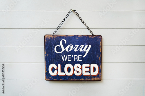 Sorry We're Closed Sign hanging on the wall