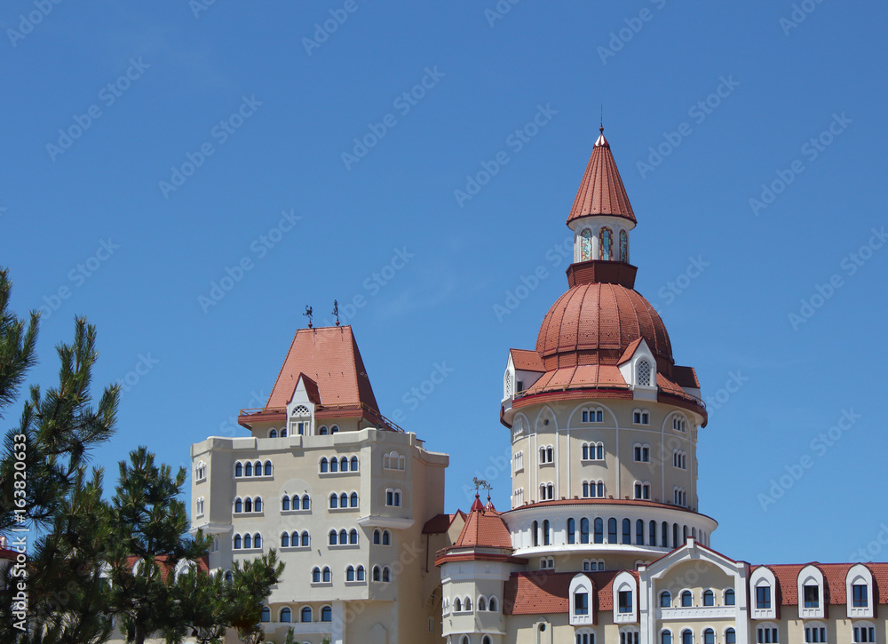 Modern castle-type building over the blue sky