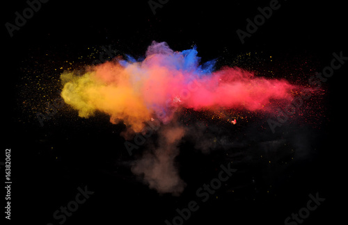 A powder paint explosion creates abstract color forms in front of a black background giving off fantastic colors formations.