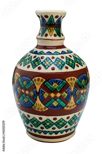 Colorful covered with glaze ceramic handmade bottle. Isolated on a white background