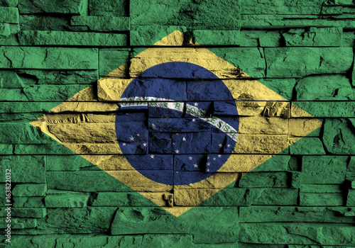Brazil flag painting on high detail of old brick wall .