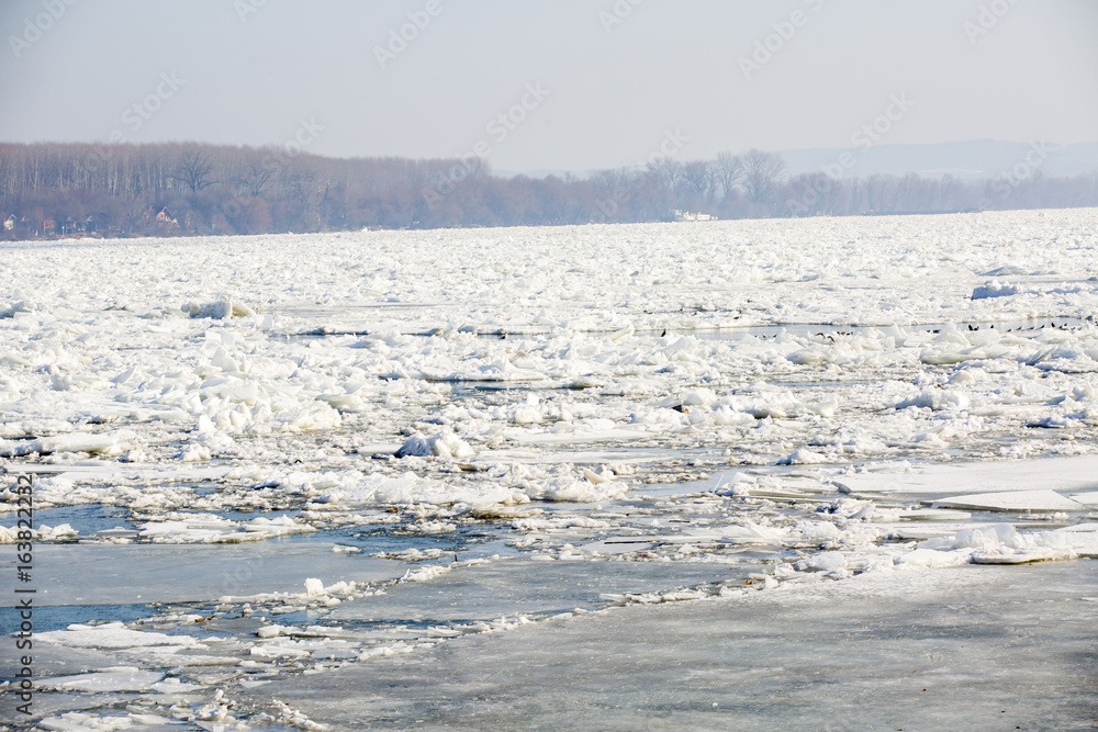 big chunk of ice in the river Danube on a winter day, near a coast big chunk of ice in the river Danube on a winter day, near a coast