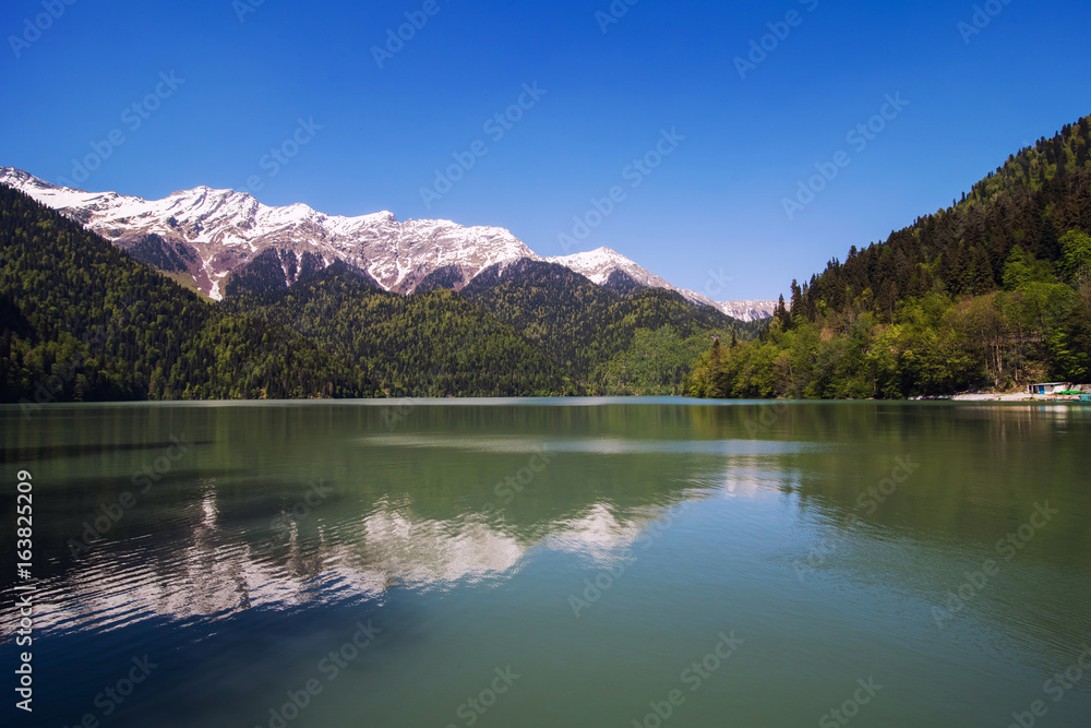 mountains reflected in the water of lake Ritsa
