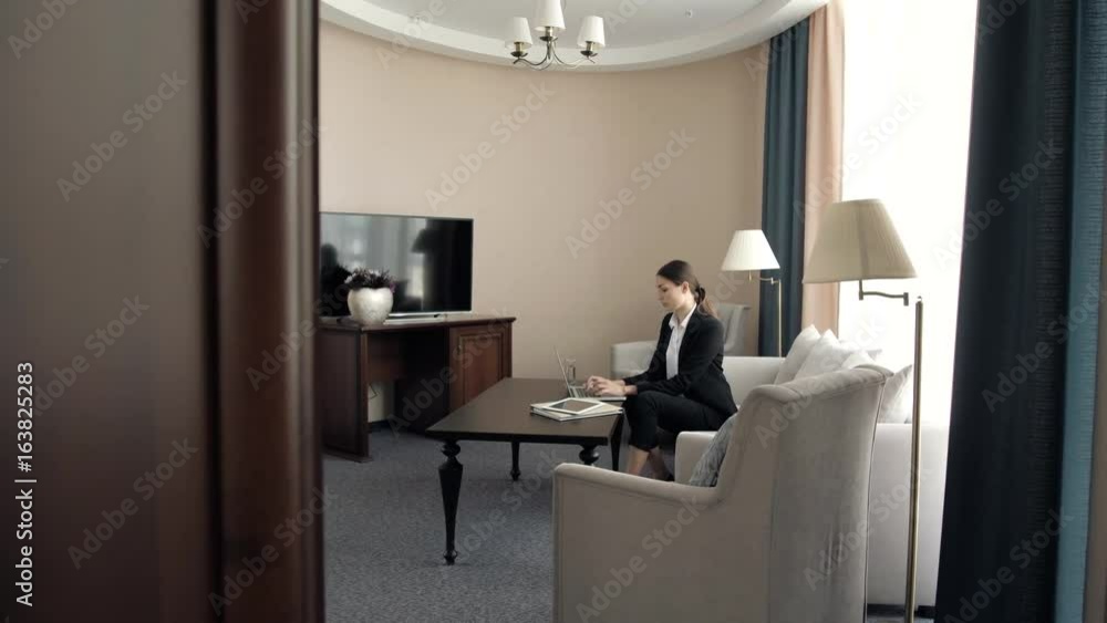 beautiful young business woman working on computer in a hotel presidetial suit room beautiful young business woman working on computer in a hotel presidetial suit room