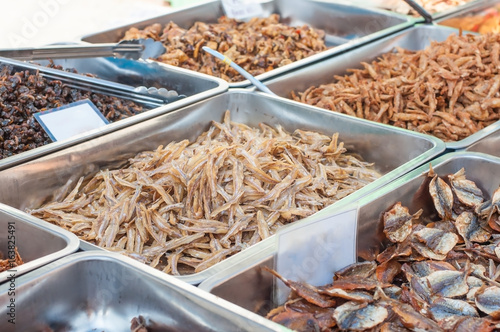 Various crispy fish and squid in aluminium tray at Thailand food street market.