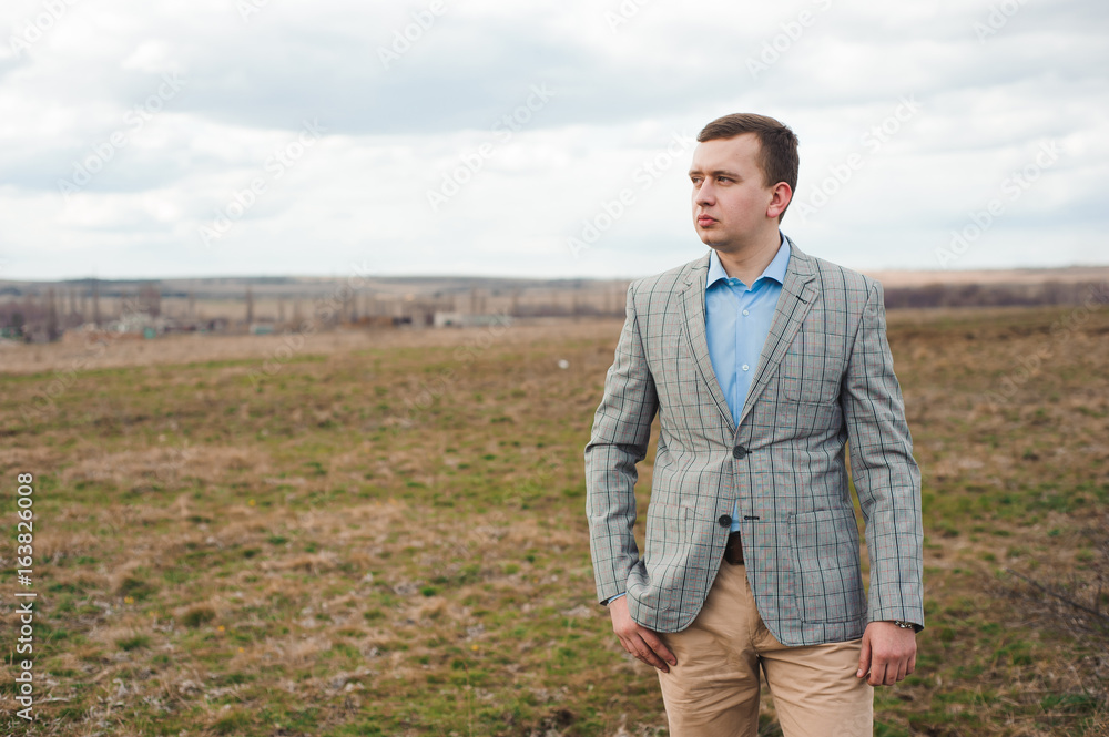 Portrait of handsome young man in a field