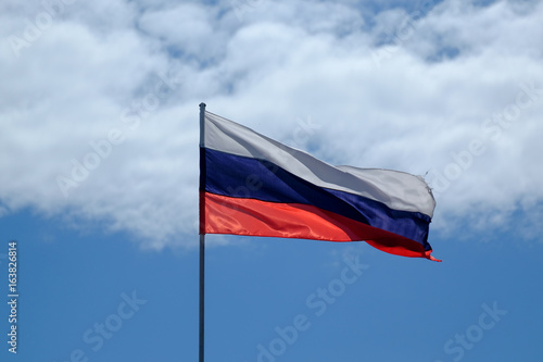 russian national flag against the blue sky