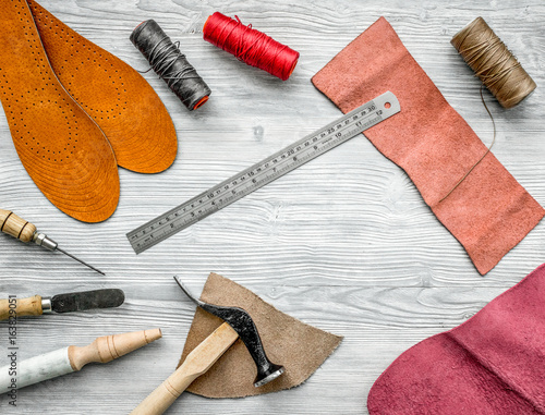 Work desk of clobber. Skin and tools on grey wooden desk background top view copyspace photo