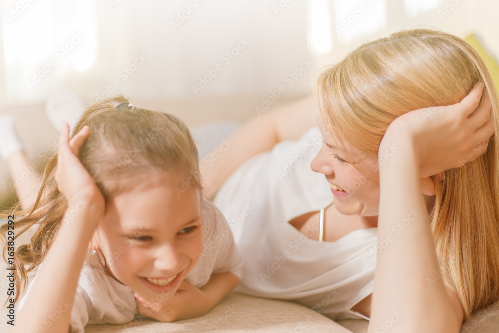 Mum and her cute daughter child girl are playing, smiling and hugging. Happy mother's day. Mum and her cute daughter child girl are playing, smiling and hugging. Happy mother's day.
