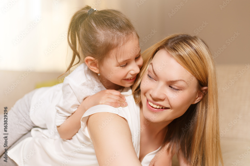 Mum and her cute daughter child girl are playing, smiling and hugging. Happy mother's day. Mum and her cute daughter child girl are playing, smiling and hugging. Happy mother's day.