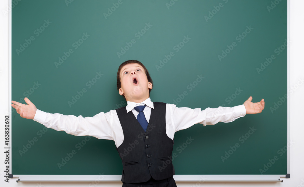 Pupil posing at school board, empty space, education concept Pupil posing at school board, empty space, education concept