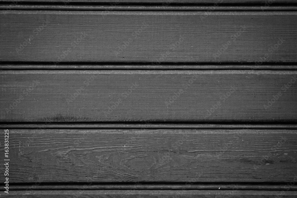 Black-painted façade boards of an old residential house