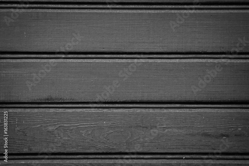 Obraz na płótnie Black-painted façade boards of an old residential house w salonie