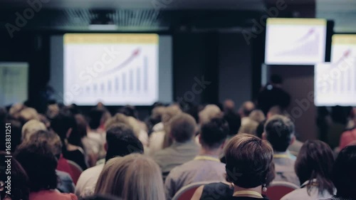 Speaker giving a talk on corporate Business Conference. Audience at the conference hall. Business event.
