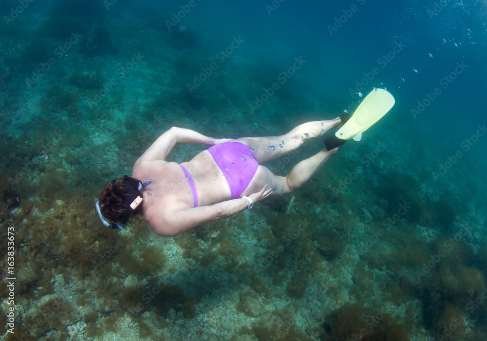 Woman snorkeling in the sea.