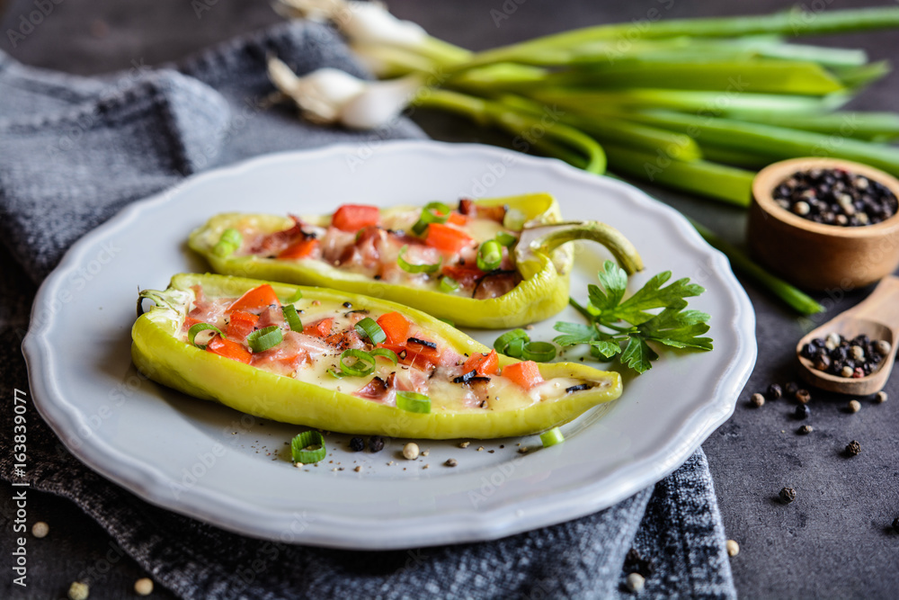 Green pepper stuffed with bacon, cheese, tomato and green onion Green pepper stuffed with bacon, cheese, tomato and green onion
