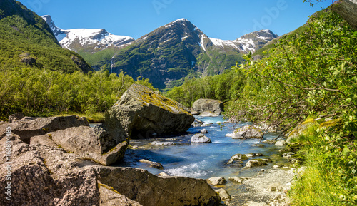 river flowing from the briksdal glacier in norway photo