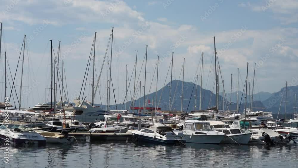 Seaside promenade in Budva, Montenegro, view of marina with boats and yachts Seaside promenade in Budva, Montenegro, view of marina with boats and yachts
