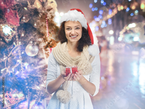 Happy woman holding Christm...