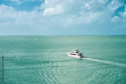 Photography touristic yachts floating by green island at Key West, Florida