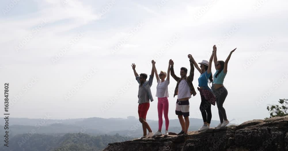 Group Of Tourists On Mountain Top Hold Raised Hands Enjoy Freedom Happy Men And Women Looking At Landscape Skyline In Morning Slow Motion 60 Group Of Tourists On Mountain Top Hold Raised Hands Enjoy Freedom Happy Men And Women Looking At Landscape Skyline In Morning Slow Motion 60