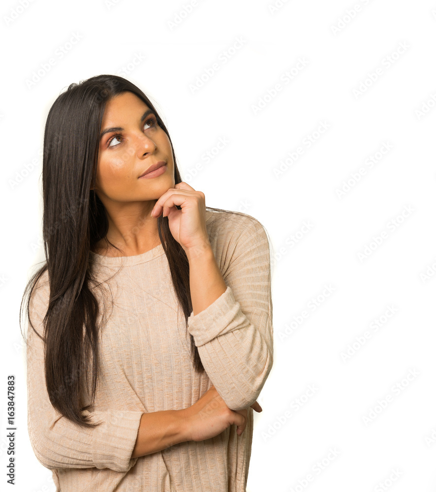 Woman looking up to side with thoughtful expression on face Woman looking up to side with thoughtful expression on face