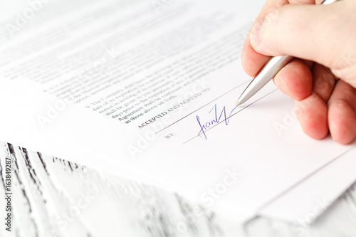 Close up on a businessman hands signing a contract