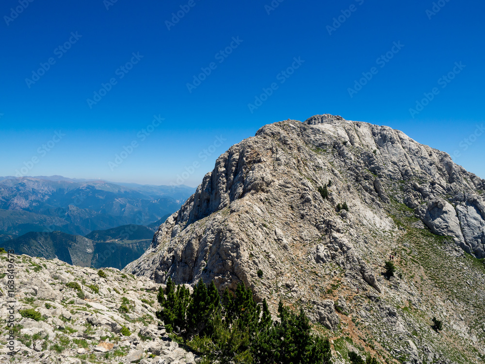 Tiny people figures climbing a mountain Tiny people figures climbing a mountain