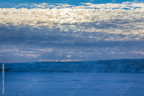 clouds over frozen lake