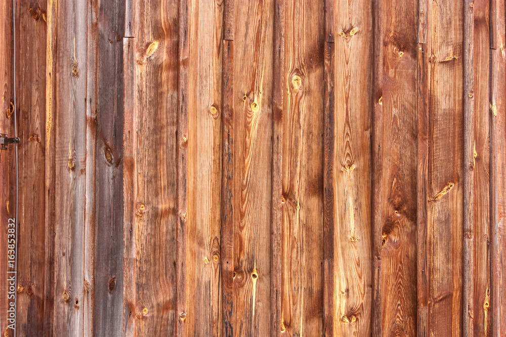 Fototapeta premium Brown background texture of vertical wooden planks logs bark.