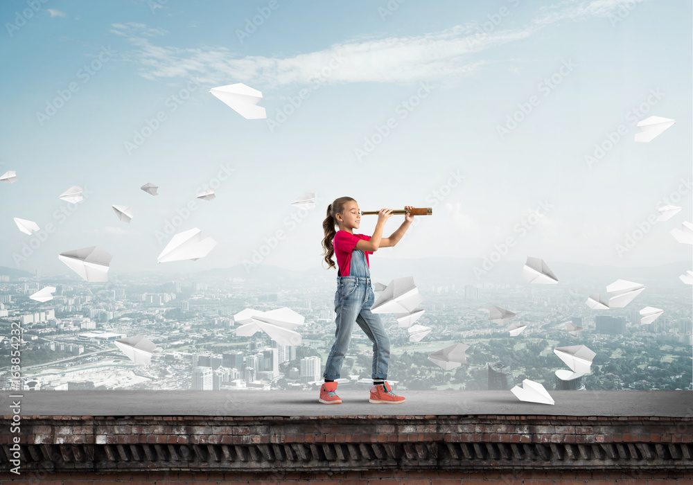 Concept of careless happy childhood with girl exploring this world