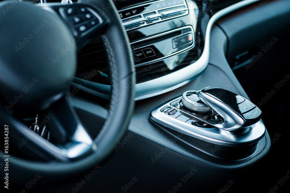 Auto. Luxury car steering wheel and dashboard