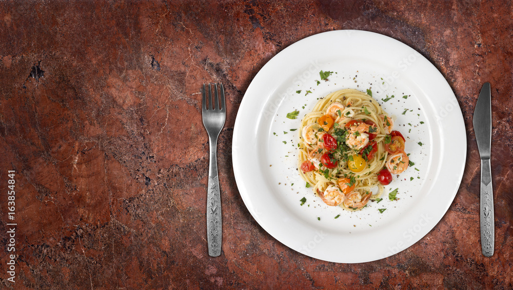 Spaghetti with shrimps or prawns on granite countertop with copyspace on side. Top view Spaghetti with shrimps or prawns on granite countertop with copyspace on side. Top view