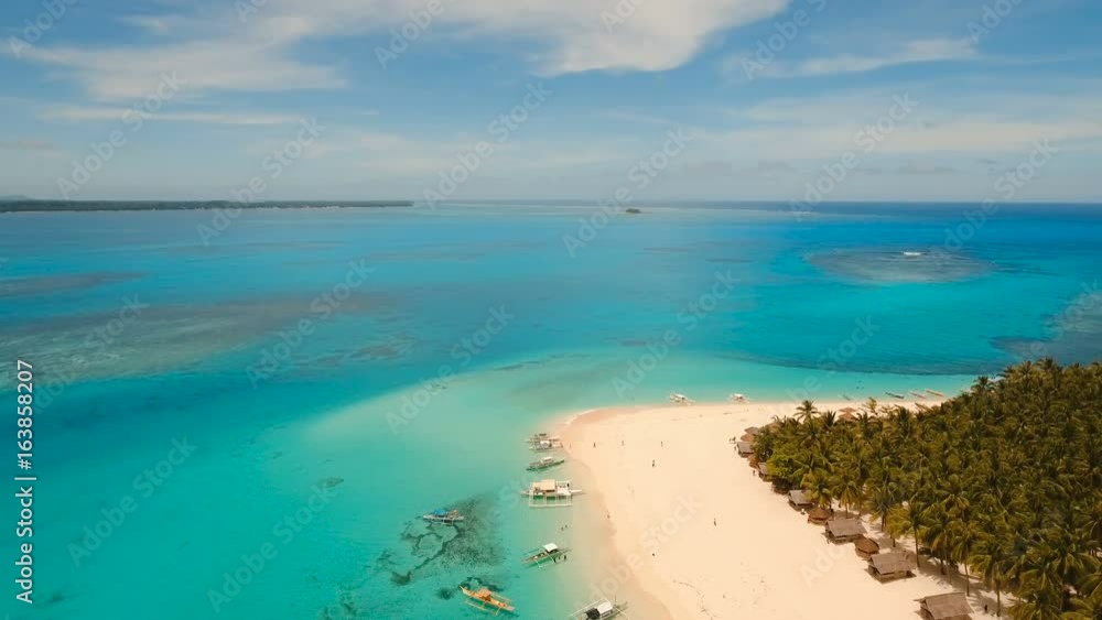 Aerial view of beautiful tropical island Daco with white sand beach. View of a nice tropical beach from the air. Beautiful sky, sea, resort. Seascape: Ocean and beautiful beach paradise. Philippines Aerial view of beautiful tropical island Daco with white sand beach. View of a nice tropical beach from the air. Beautiful sky, sea, resort. Seascape: Ocean and beautiful beach paradise. Philippines