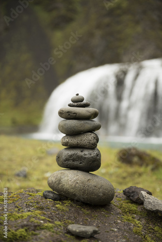 Stack of pebbles and waterfall