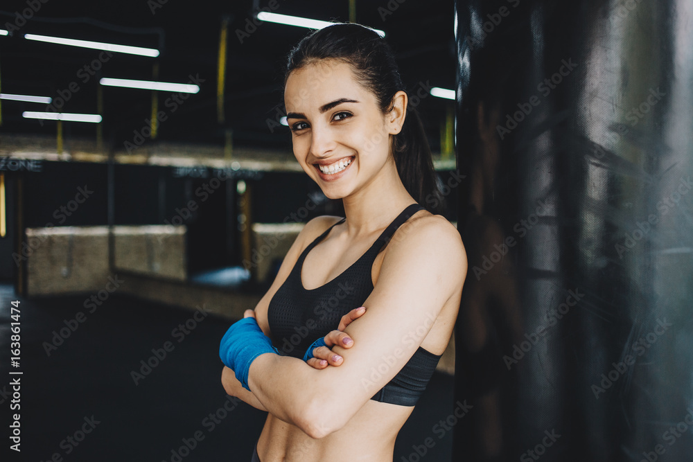 Beautiful and fit female fighter getting prepared for the fight or training Beautiful and fit female fighter getting prepared for the fight or training