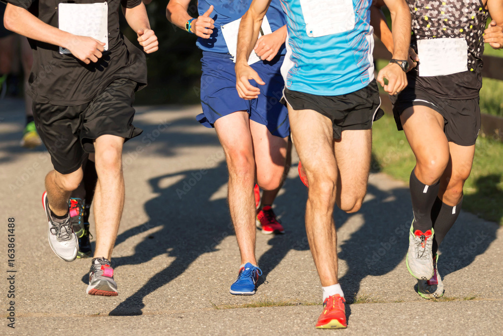 Men racing a 5K in the summer Men racing a 5K in the summer