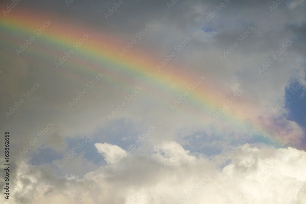 rainbow on cloudy sky after storm