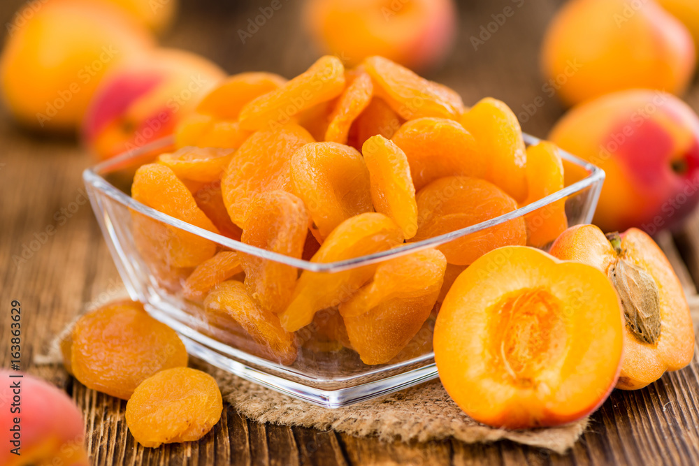 Apricots (dried) on wooden background (selective focus) Apricots (dried) on wooden background (selective focus)