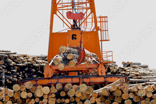 Loglift crane transferring logs to log stack