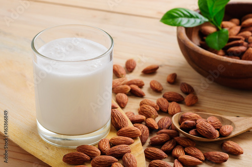 Almond milk with almond on a wooden table