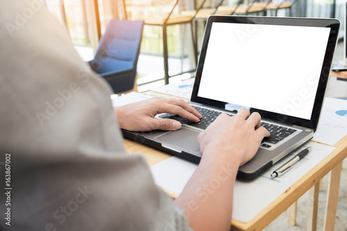 Business man working by using laptop computer. hand typing on laptop keyboard in his office